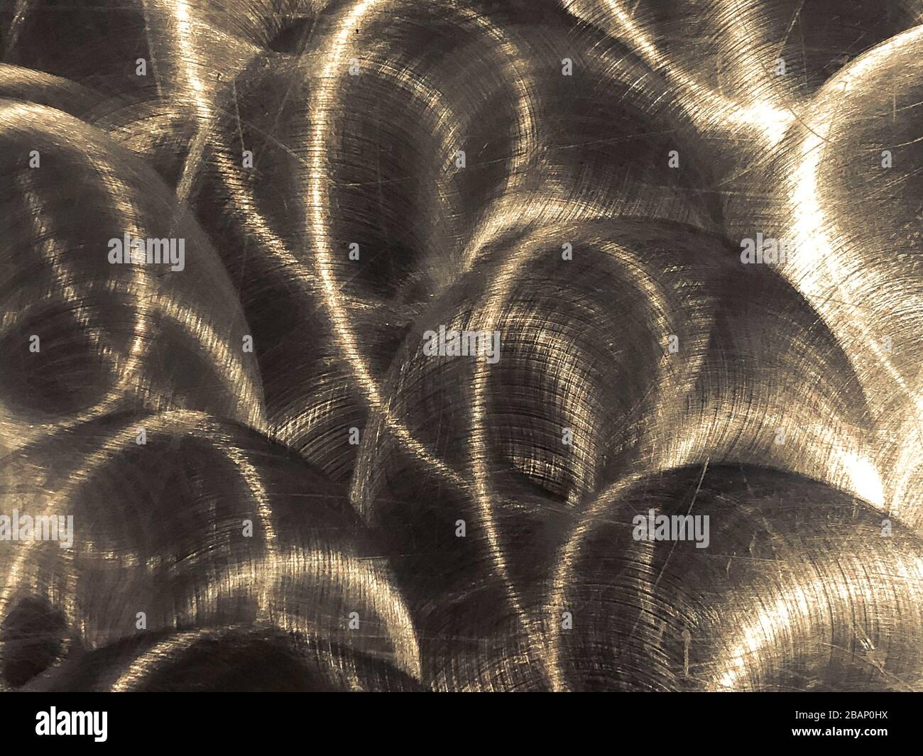Close up of grungy, industrial brushed metal sheet with circular patterns Stock Photo