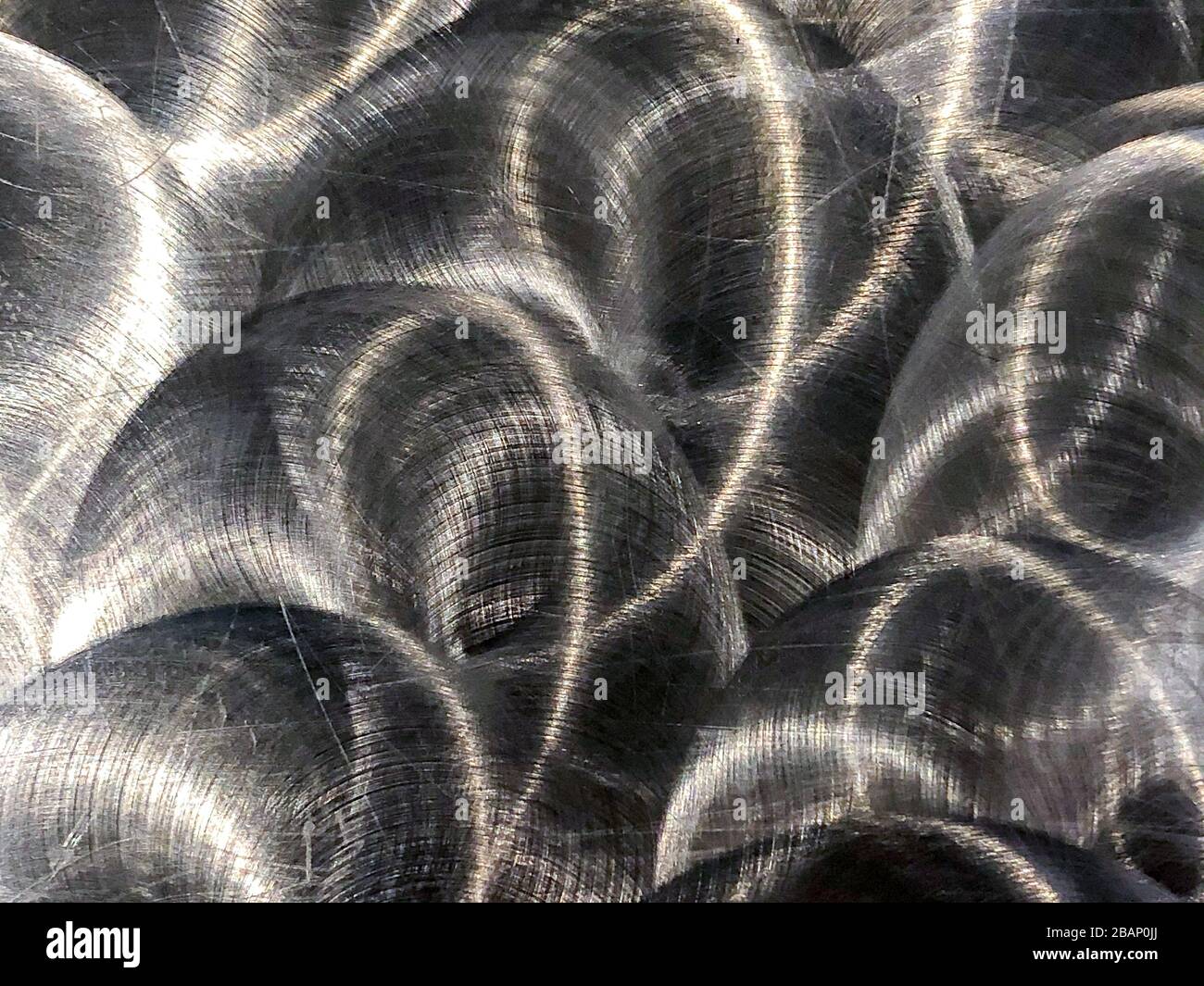 Close up of brushed metal that has circular, grungy patterns Stock Photo