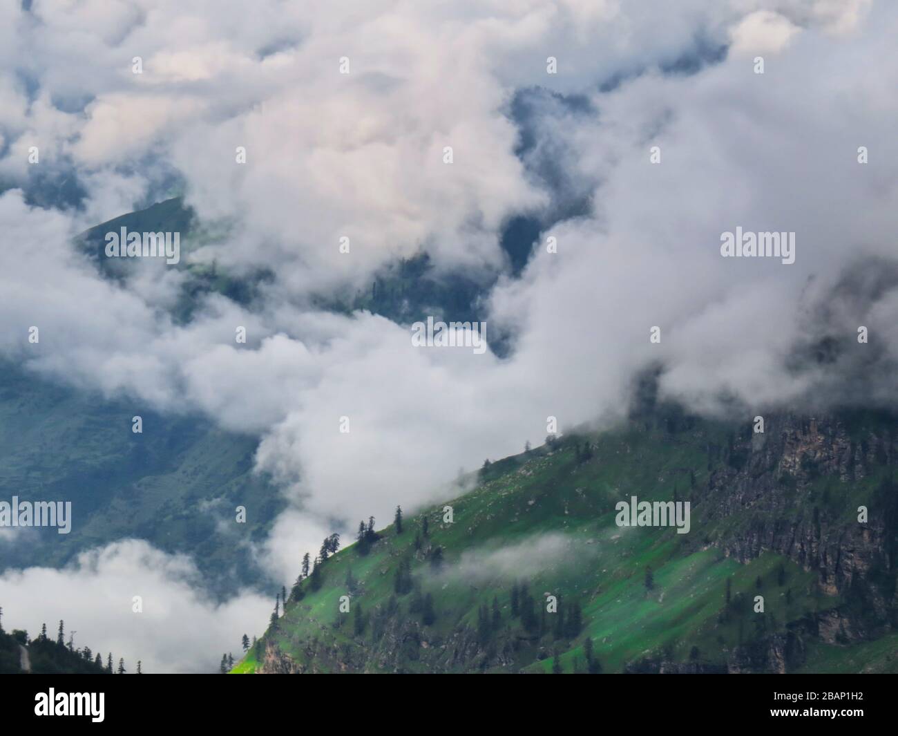 Scenic view of clouds over mountains Stock Photo - Alamy