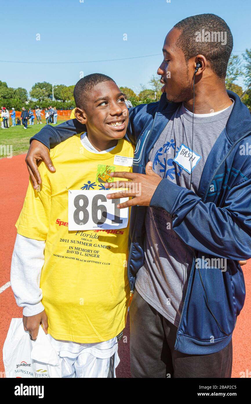 Miami Florida,Liberty City,Traz Powell Stadium,Special Olympics,needs,Track & Field mentally disabled handicapped special needs,challenged,volunteer v Stock Photo