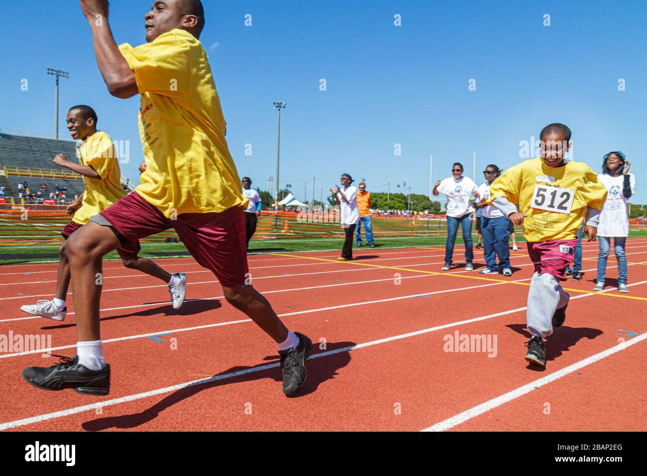 Miami Florida,Liberty City,Traz Powell Stadium,Special Olympics,needs,Track & Field mentally disabled handicapped special needs,challenged,volunteer v Stock Photo