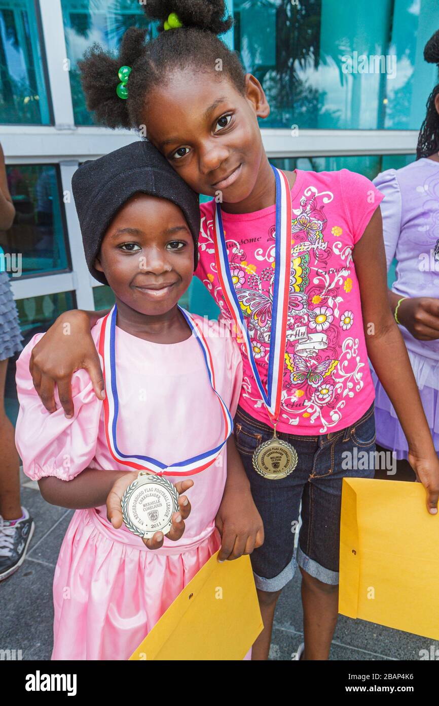 North Miami Beach Florida,Police Station,Neighborhood Football League Awards Ceremony,medal,medallion,Black girl girls,youngster,female kids children Stock Photo
