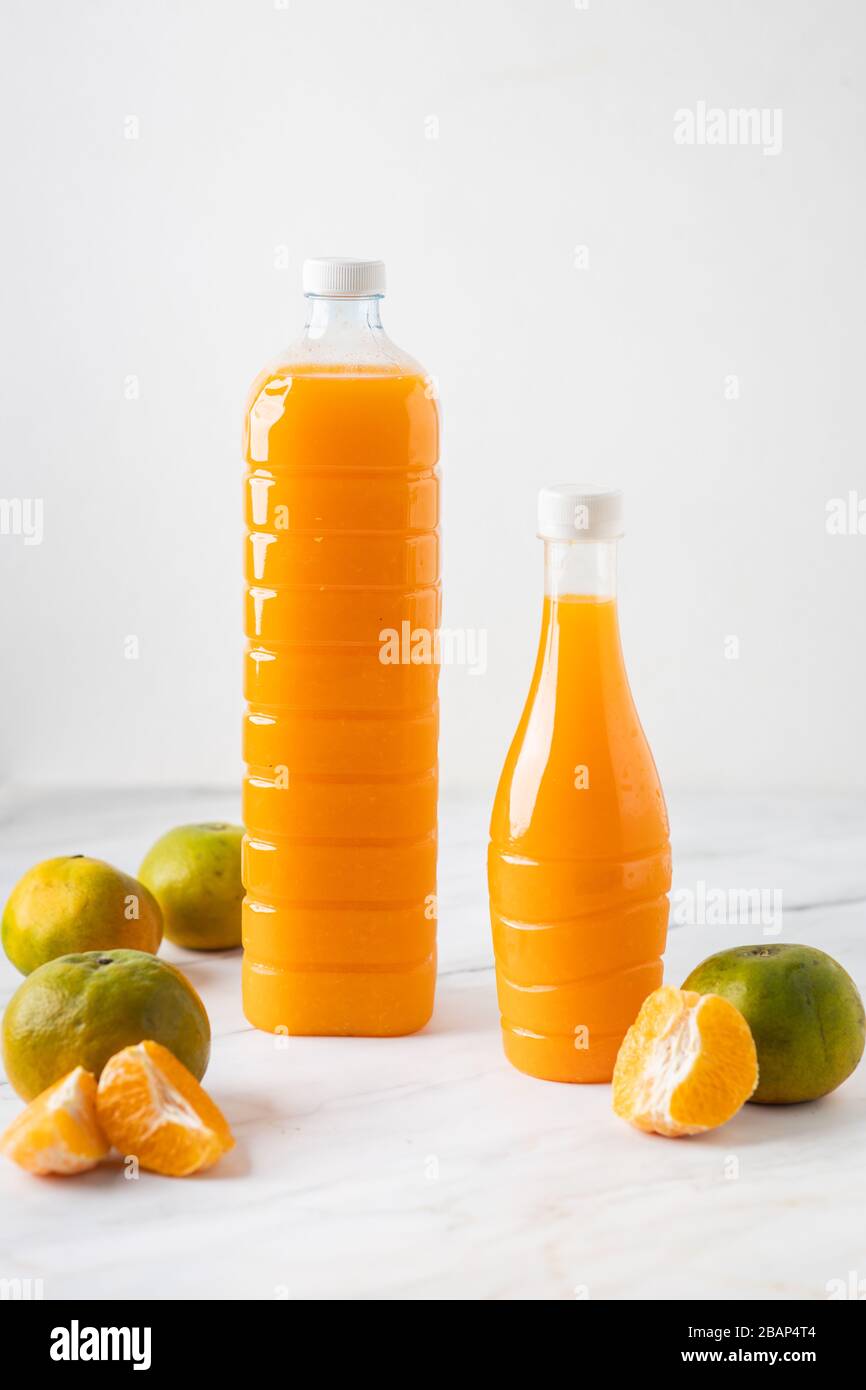 This is the picture of Orange Juice in  in a bottle on marble with oranges. Stock Photo