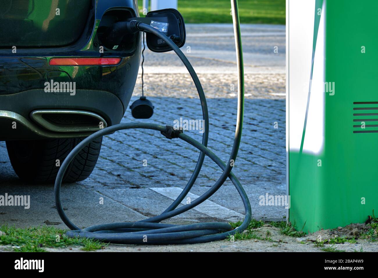 Electrical car charging battery while parking Stock Photo Alamy