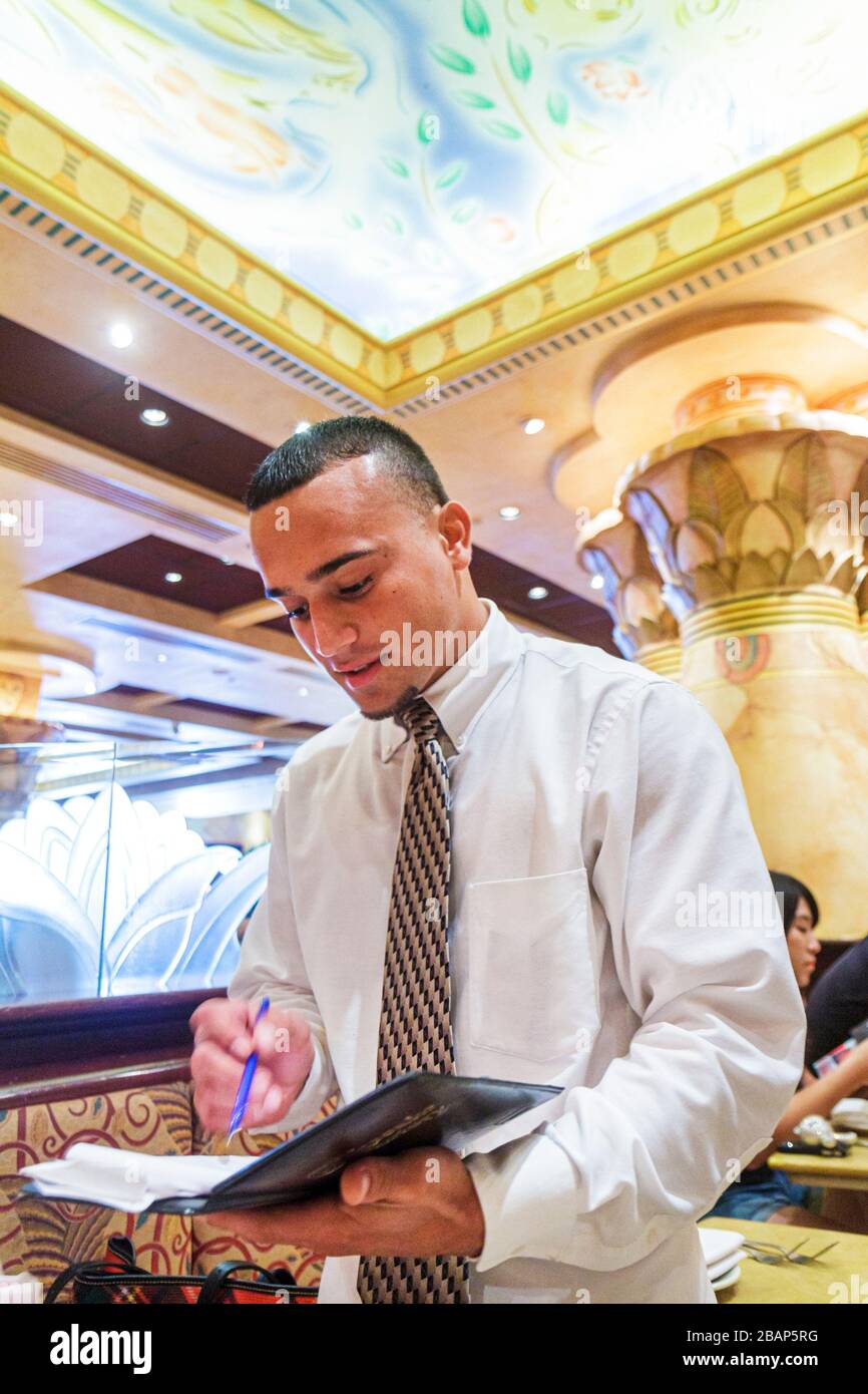 Miami Florida,Dadeland Mall,Cheesecake Factory,restaurant restaurants food dining eating out cafe cafes bistro,interior inside,waiter waiters server s Stock Photo