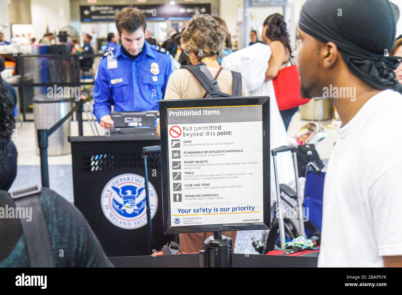 Miami Florida International Airport MIA,TSA,prohibited items,sign,logo,information,security,screening,Homeland Security,Black Blacks African Africans Stock Photo