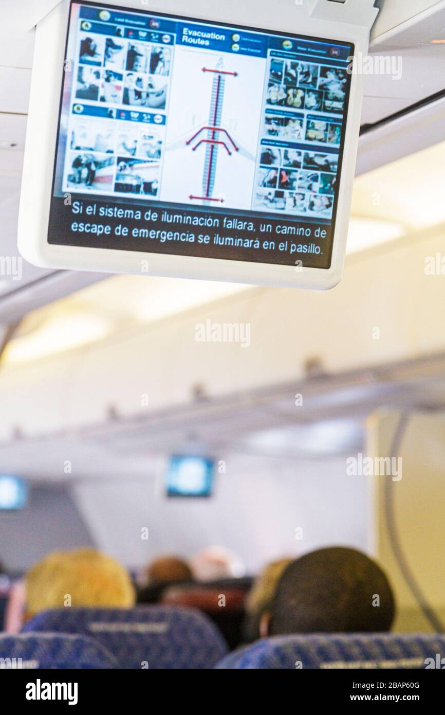 Miami Florida International Airport MIA,American Airlines,inflight,passenger cabin,safety instructions,video screen,monitor,evacuation highway Routes, Stock Photo