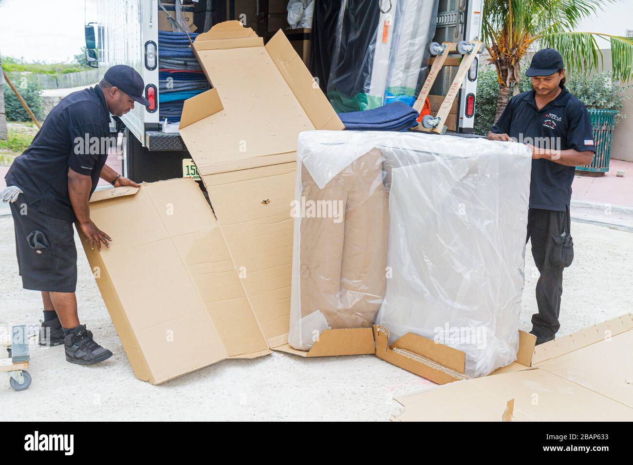 Miami Beach Florida,Macy's,driver,delivery,delivering,deliveryman,furniture,mover,recliner chair,Asian Asians ethnic immigrant immigrants minority,Bla Stock Photo