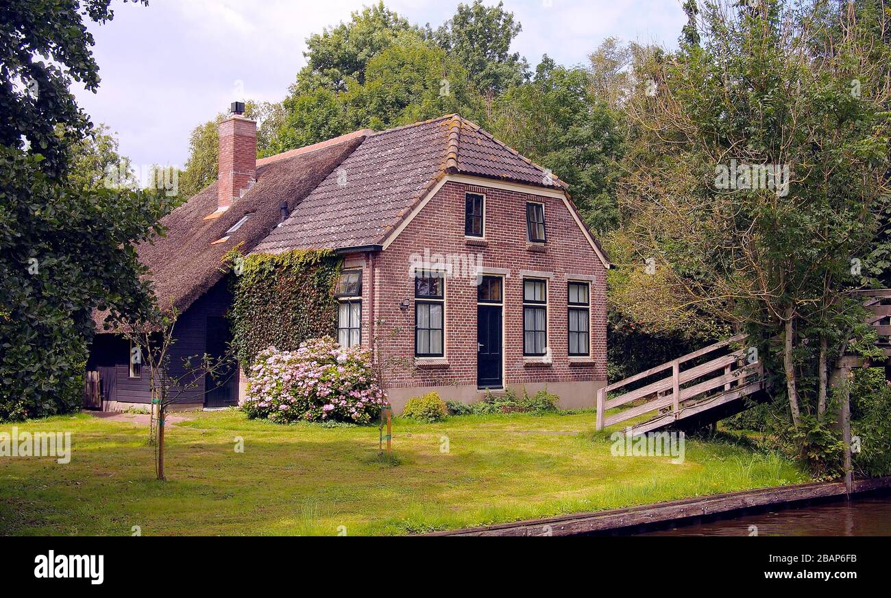 Classic House Surrounded by Green Garden Stock Photo