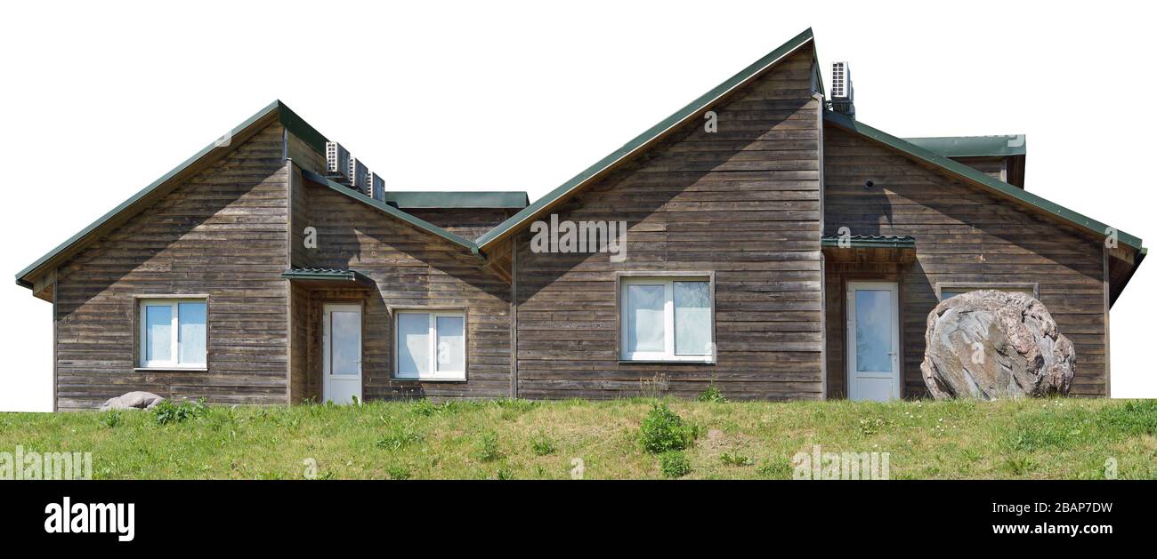 Usual noname wooden modern  rural shed  barn for storage of firewood and agricultural tools on grassy hill. Isolated on white with patch Stock Photo