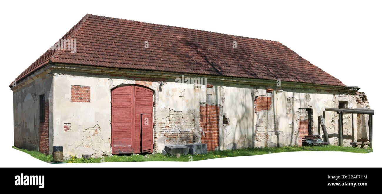Long ruined brick village barn for farm tools and animals. Isolated on white Stock Photo