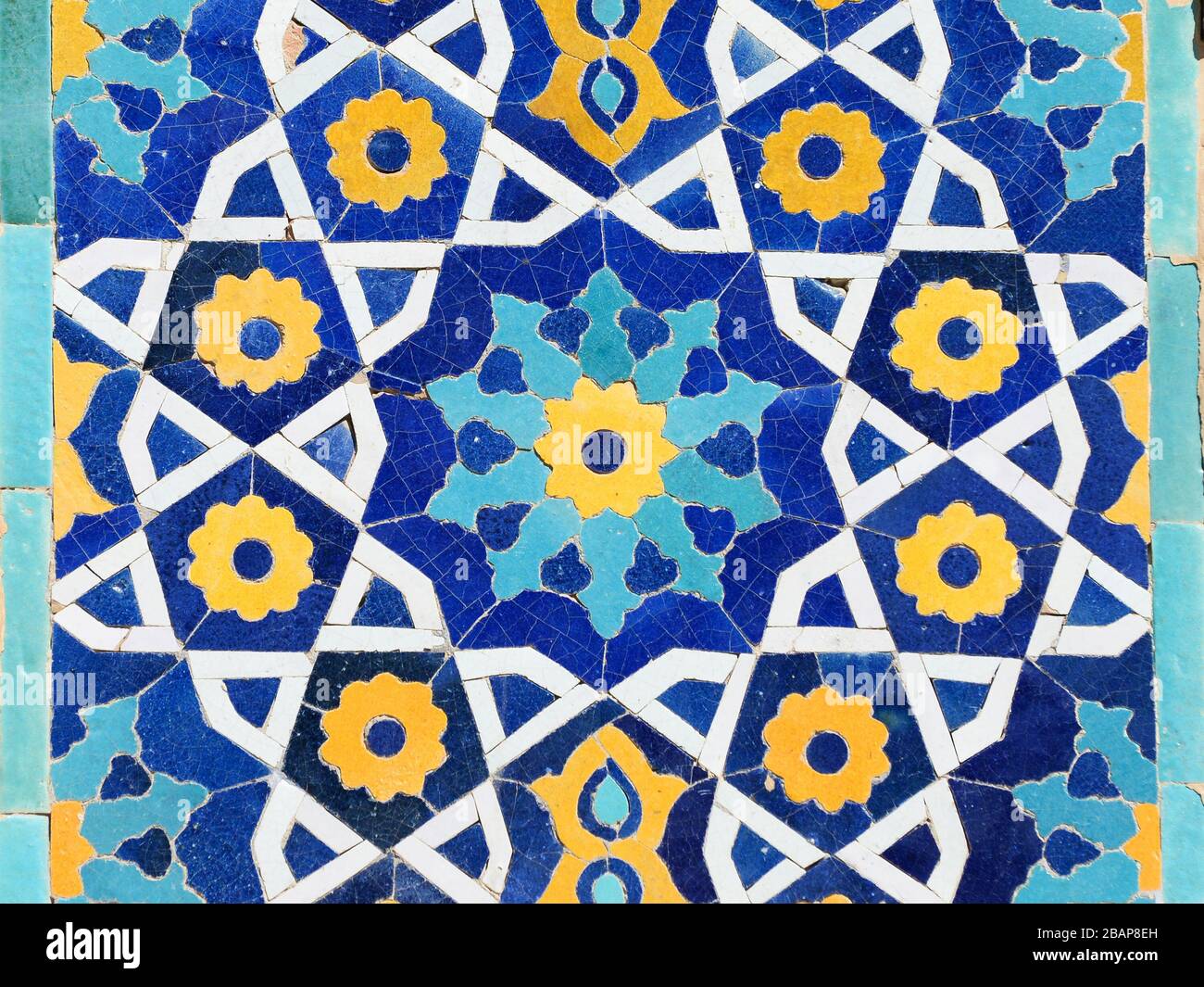 Close up view showing colorful details, islamic ornaments and yellow, blue and white ceramic tiles in Bukhara, Uzbekistan. Islamic pattern. Stock Photo
