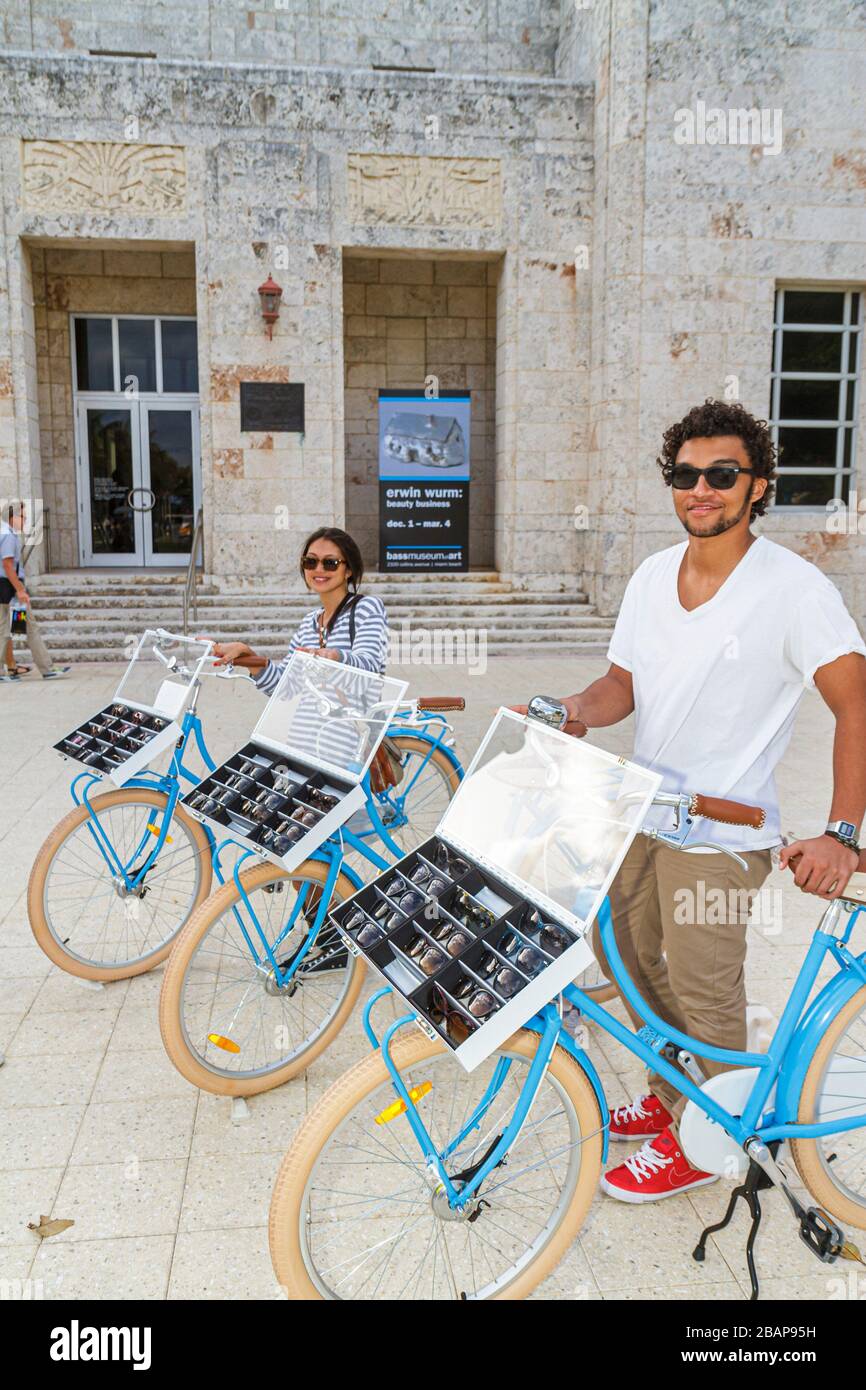 Miami Beach Florida,Warby Parker Eyewear eyeglasses street bicycle riding display case,selling vendor Hispanic woman female working man male Stock Photo