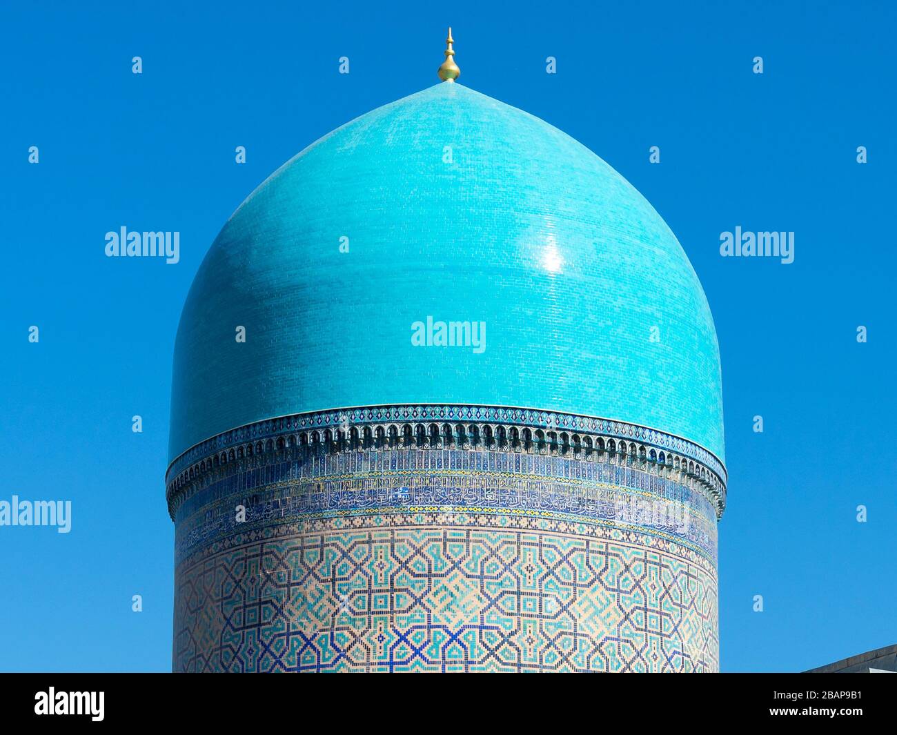 Big dome in turquoise color with detailed ornaments of blue ceramic tiles at Tilya Kori Madrasah and Mosque. Cupola at Registan Samarkand, Uzbekistan. Stock Photo
