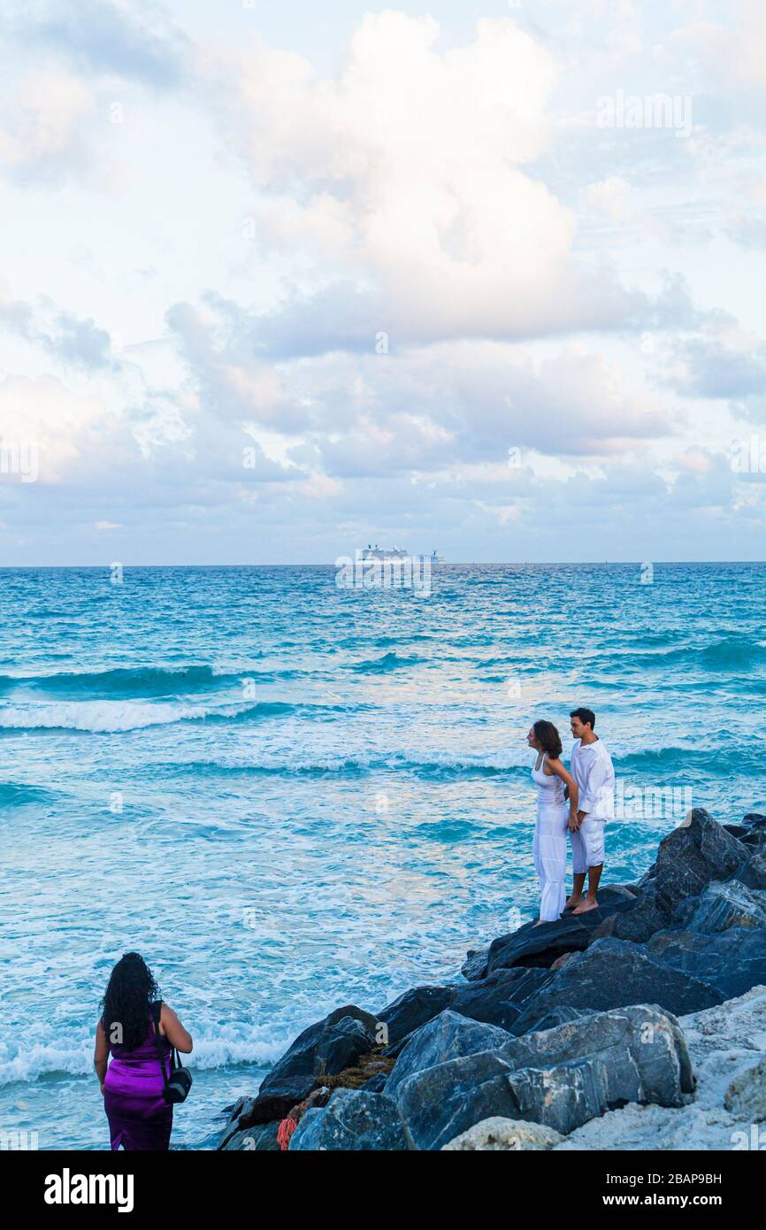 Miami Beach Florida,South Pointe Park,Point,Atlantic Ocean water adult adults woman women female lady,man men male,couple,jetty,breakwater,visitors tr Stock Photo
