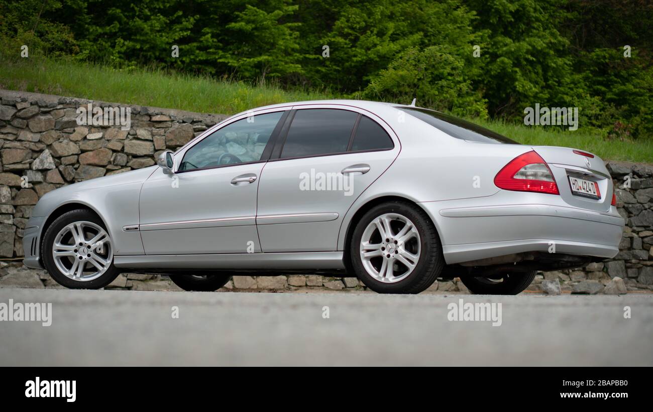 https://c8.alamy.com/comp/2BAPBB0/beautiful-avantgarde-mercedes-benz-w211-year-2008-manual-transmission-winter-rims-isolated-no-people-in-an-empty-parking-lot-2BAPBB0.jpg