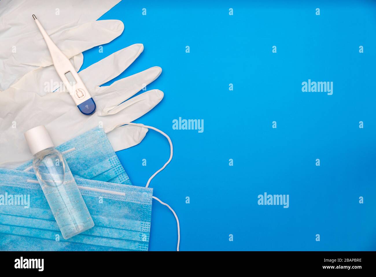 flat lay image of pandemic supplies on classic blue background Stock Photo