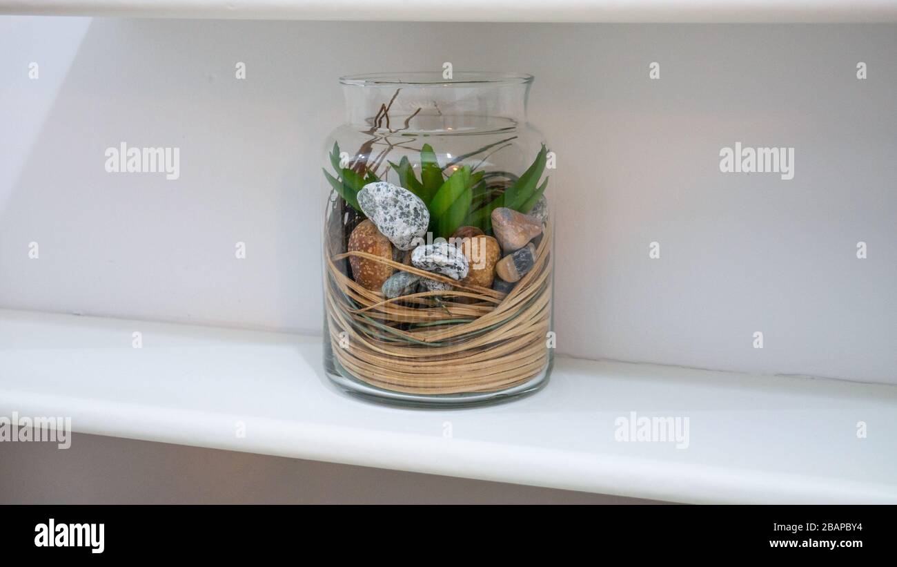 Pebbles In A Bottle Isolated On White background Stock Photo