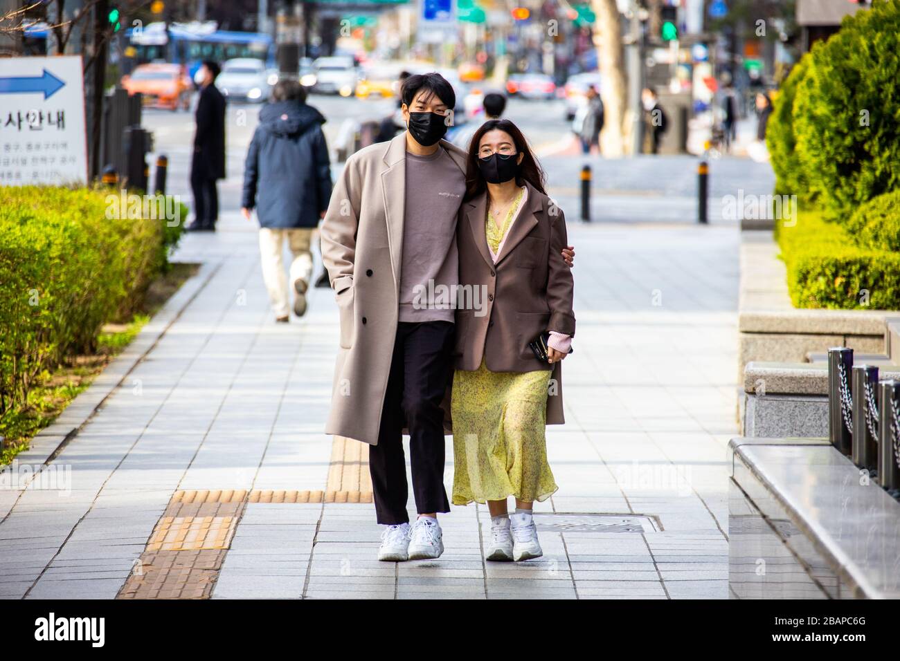 Attractive young couple wearing masks during the Coronavirus pandemic, Seoul, South Korea Stock Photo