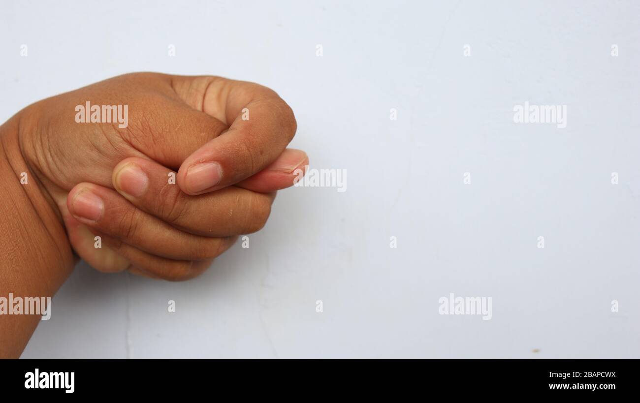 Left hand photographed with the meaning of a symbol and white background, not in focus. blurry Stock Photo