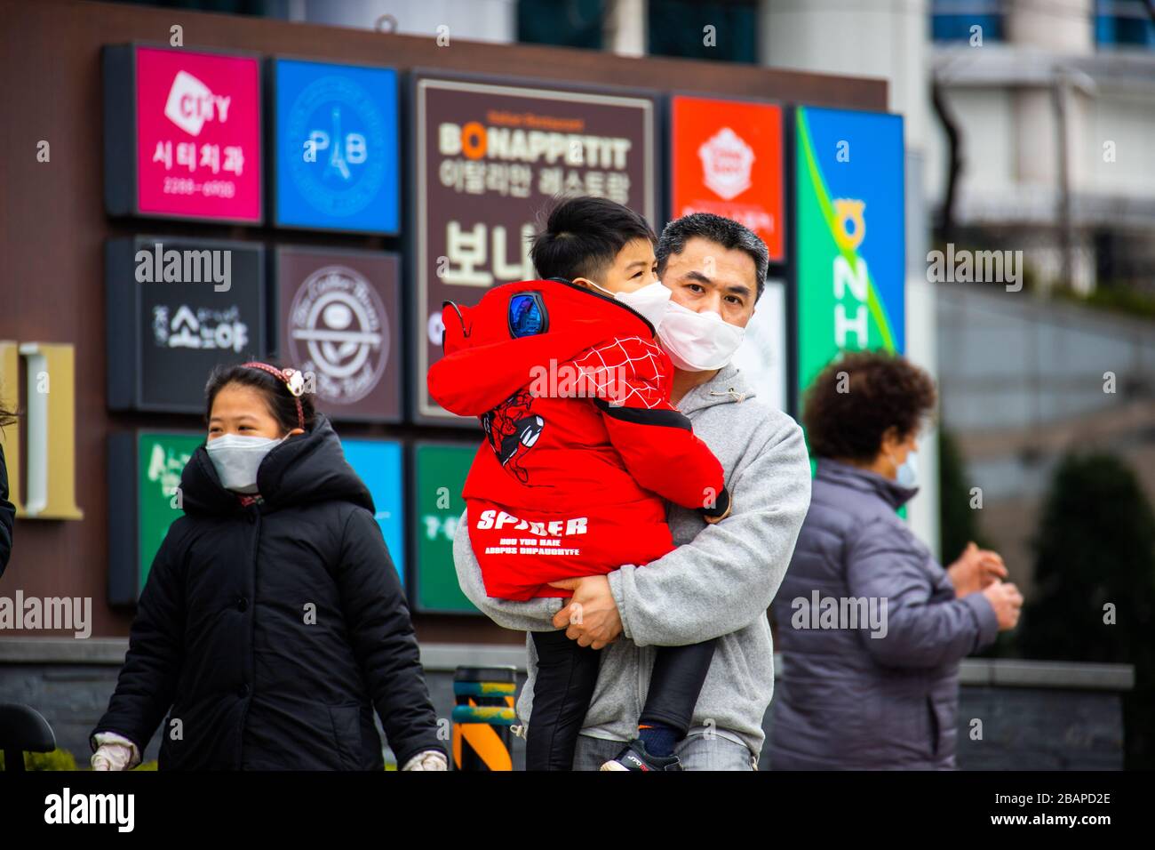 Father and his young son wearing masks during the Coronavirus pandemic ...