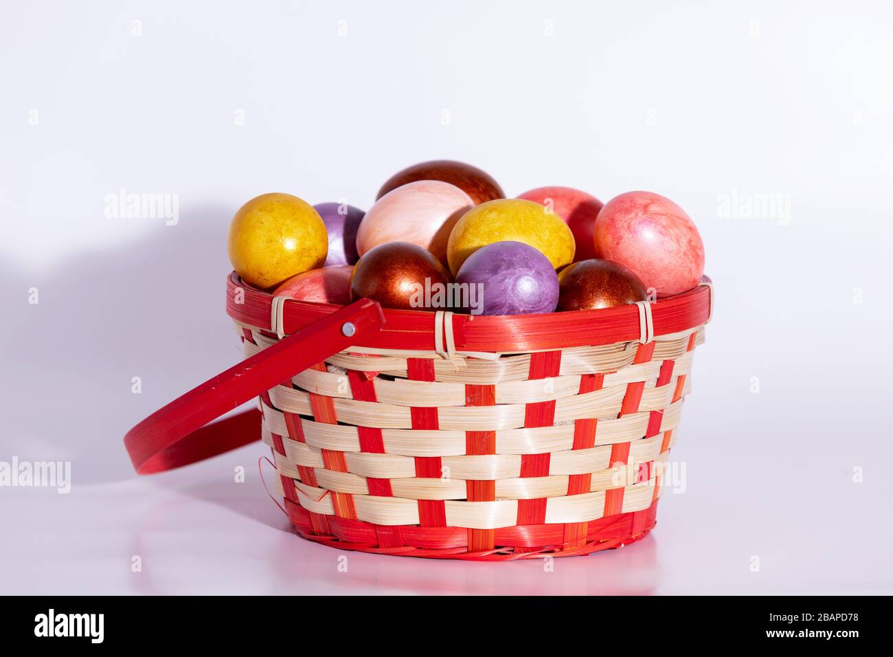 Easter painted eggs in basket isolated on white Stock Photo - Alamy