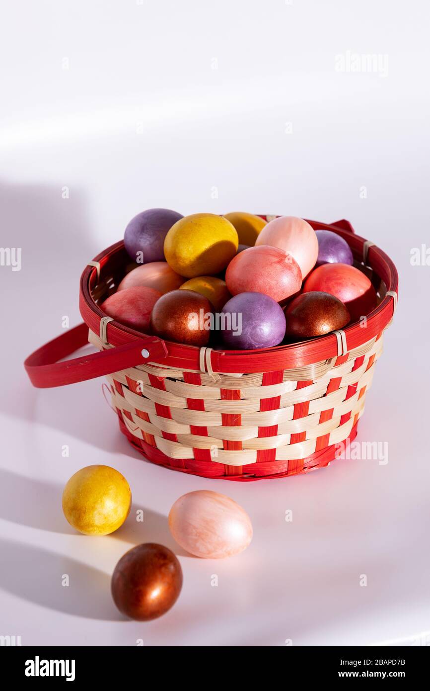Easter painted eggs in basket isolated on white Stock Photo
