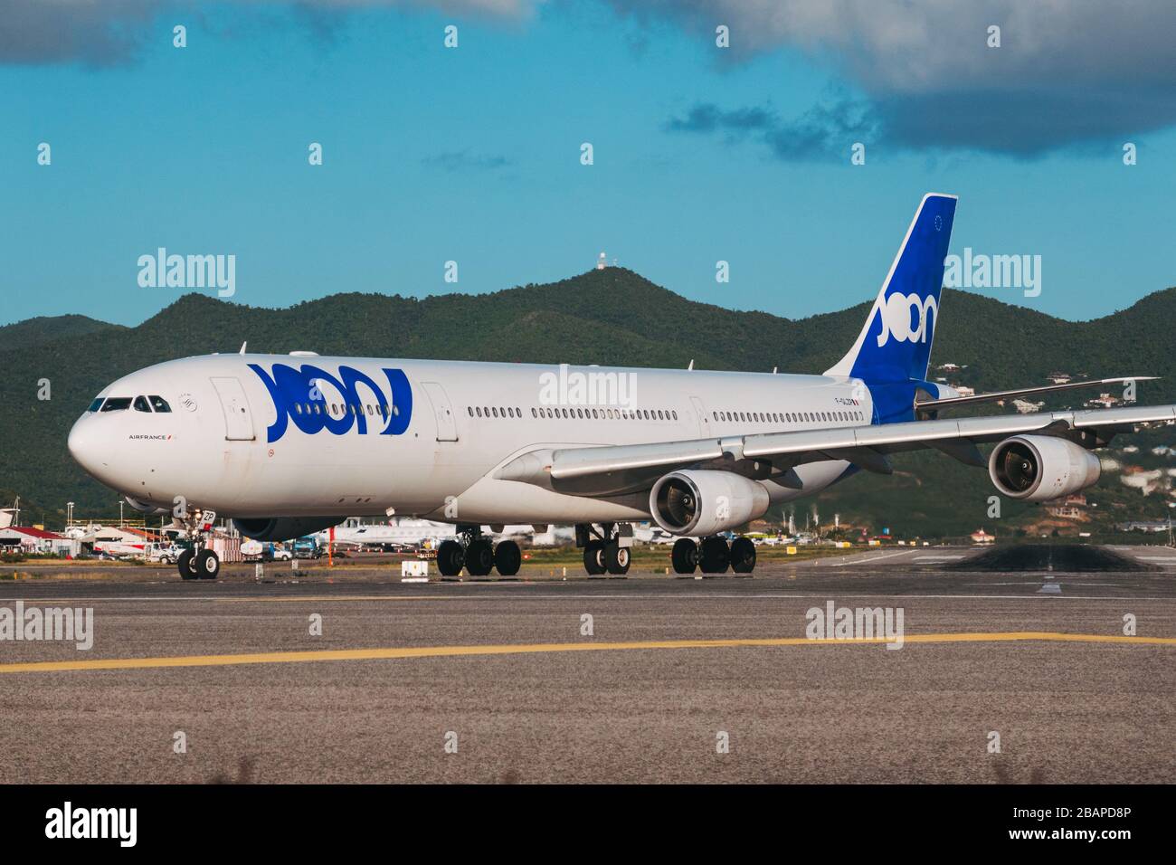 An Airbus A340-300 operated by Air France, in the now-defunct subsidiary Joon's branding. Lining up for takeoff at St. Maarten Stock Photo