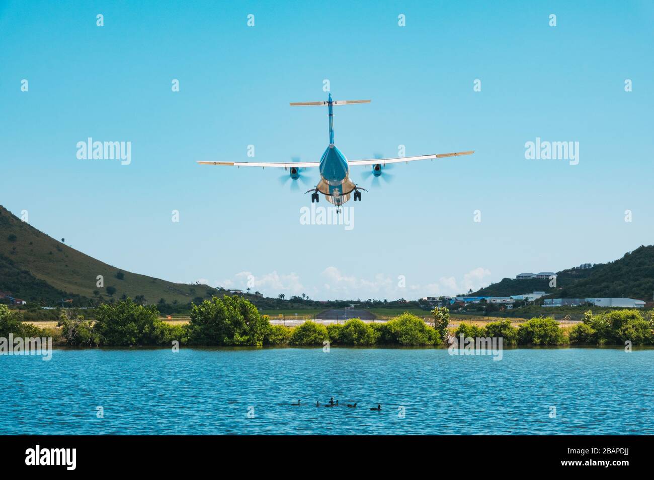 An ATR 42 regional aircraft comes in to land at Grand Case-Espérance Airport, Saint Martin a collectivity in the French Caribbean Stock Photo