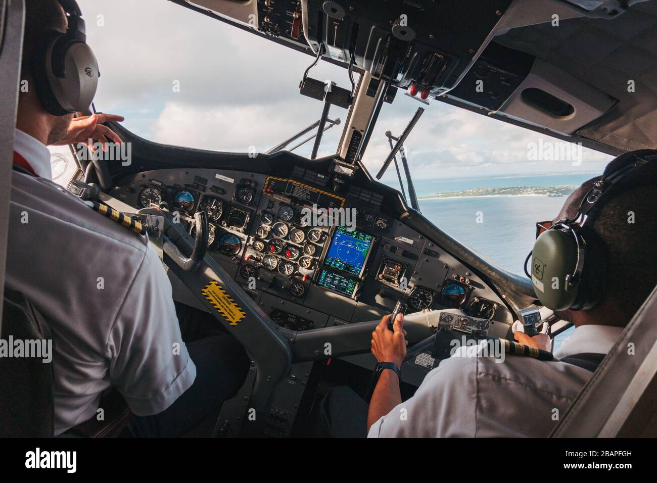 View of the flight deck while turning onto final approach in a DHC-6 Twin Otter at Princess Juliana International Airport, Sint Maarten Stock Photo