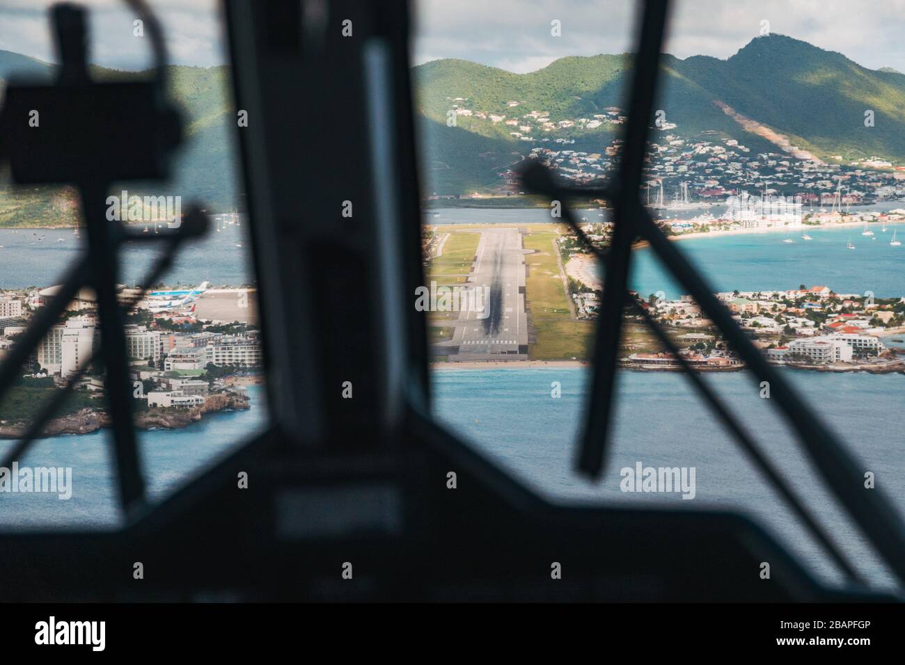 The view of the runway from the cockpit on approach to St Maarten Princess Juliana International Airport over Maho Beach Stock Photo