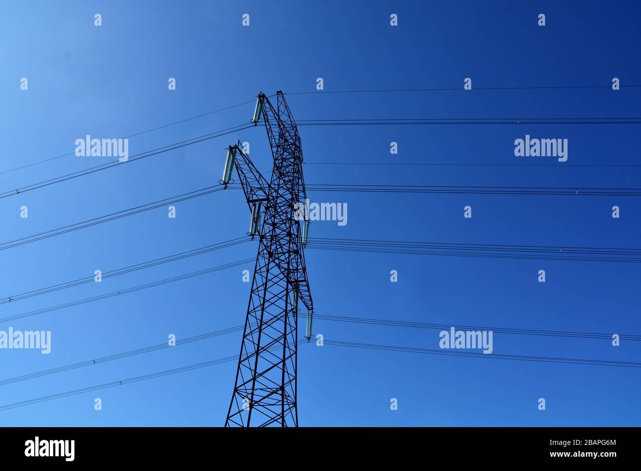 High voltage tower and power lines with a blue sky background Stock ...
