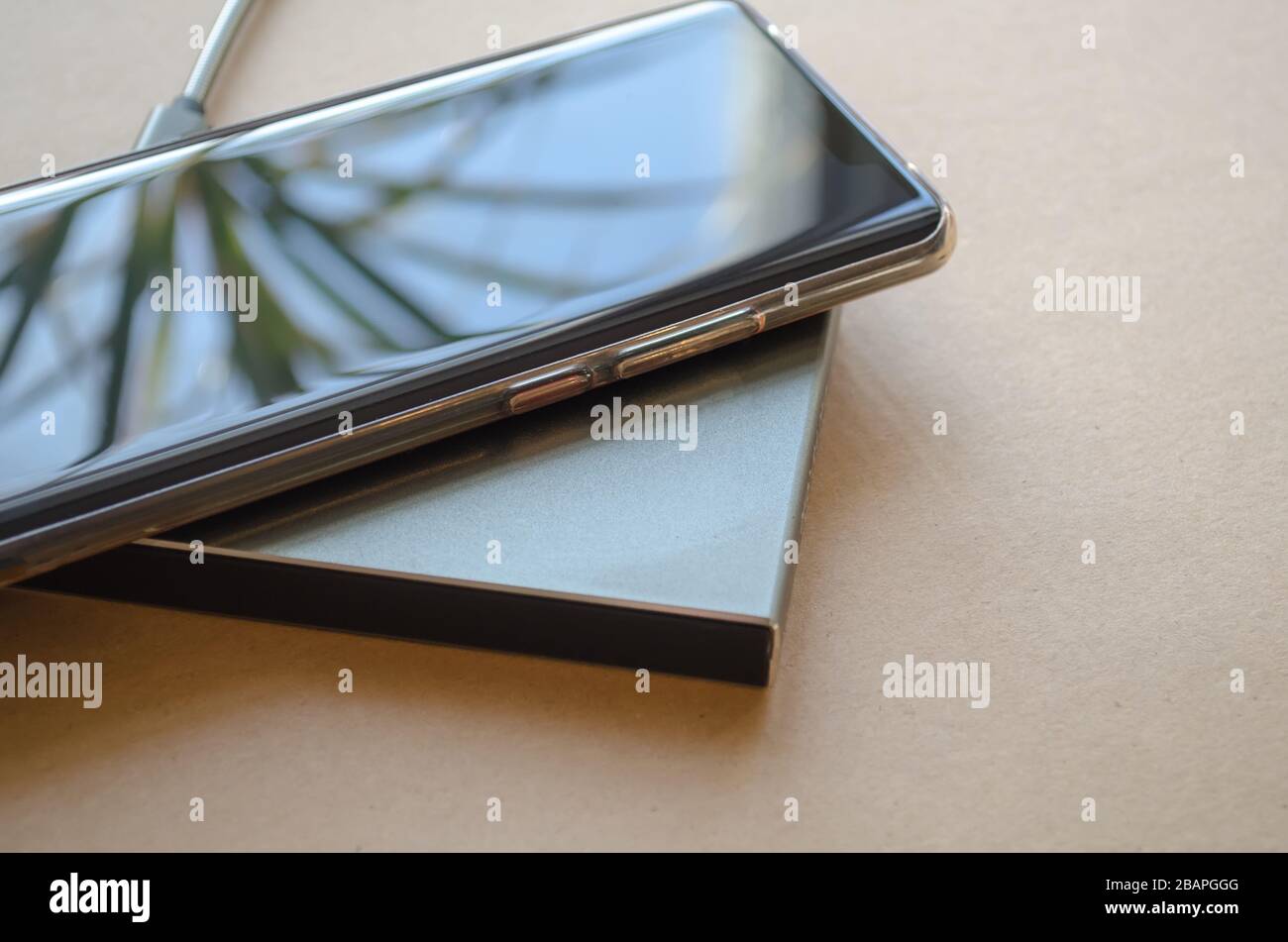 Smartphone wireless charging on induction charger. Wireless charger Stock Photo
