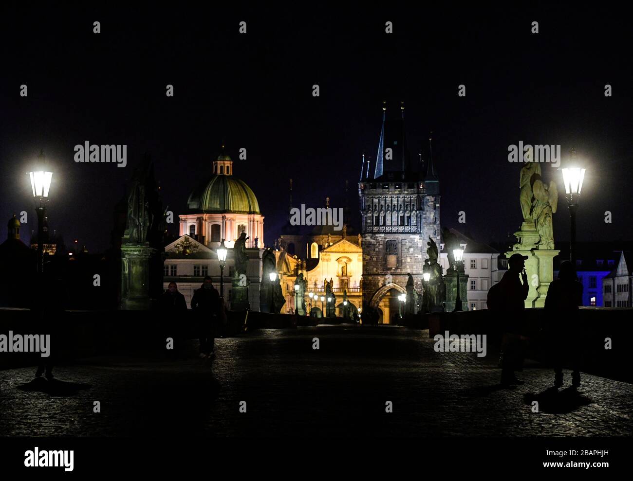 Prague, Czech Republic. 28th Mar, 2020. Charles Bridge and surrounding monuments are seen before turn the lights off, in Prague, Czech Republic, on March 28, 2020. Czech Republic joined global climate conservation campaign Earth Hour by turning off public lighting for one hour. Credit: Roman Vondrous/CTK Photo/Alamy Live News Stock Photo