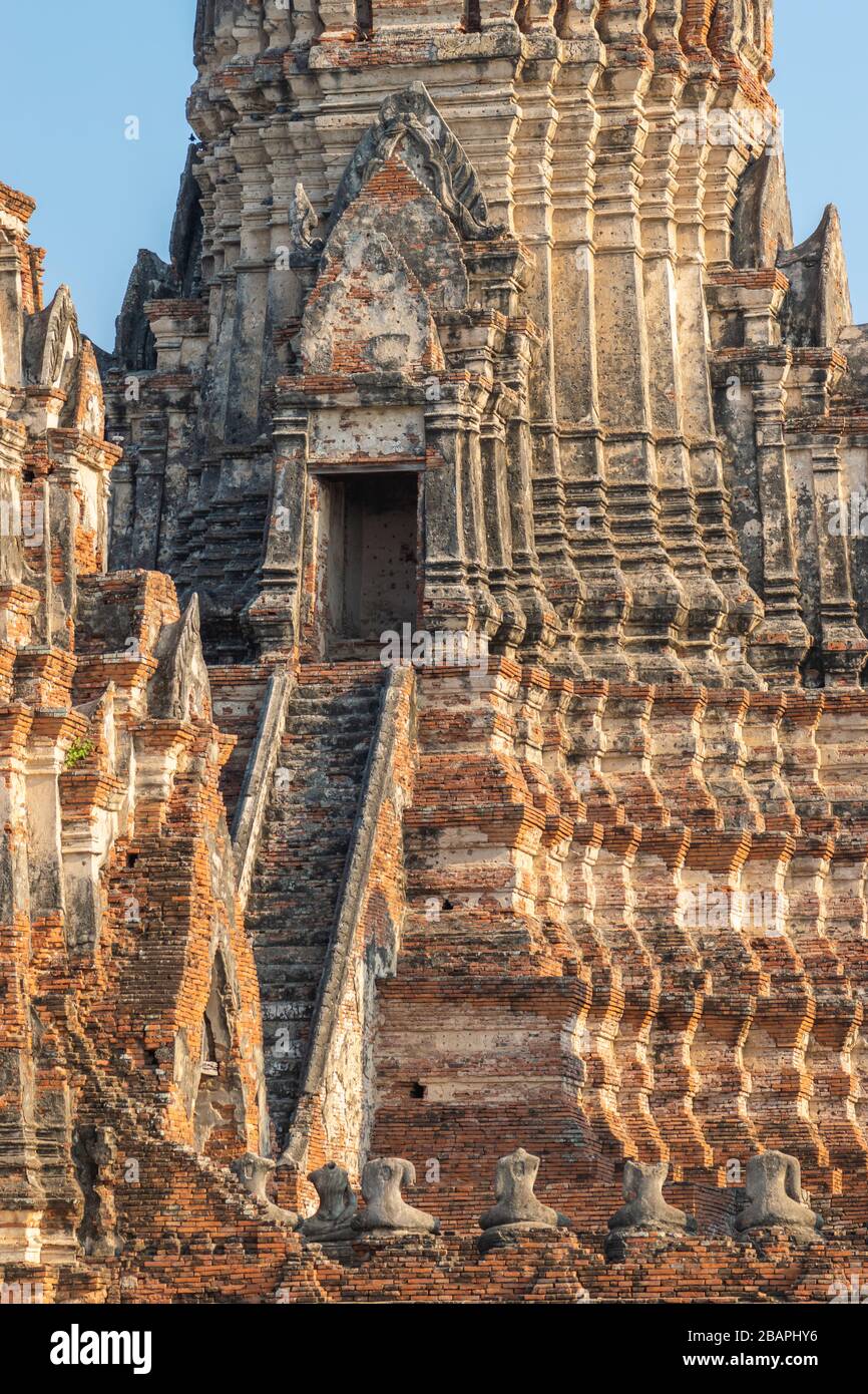 Architekture Wat Chaiwatthanaram temple in Thailand, Ayutthaya illuminated by yellow evening sun and in the background of blue and clear sky. Doors is Stock Photo