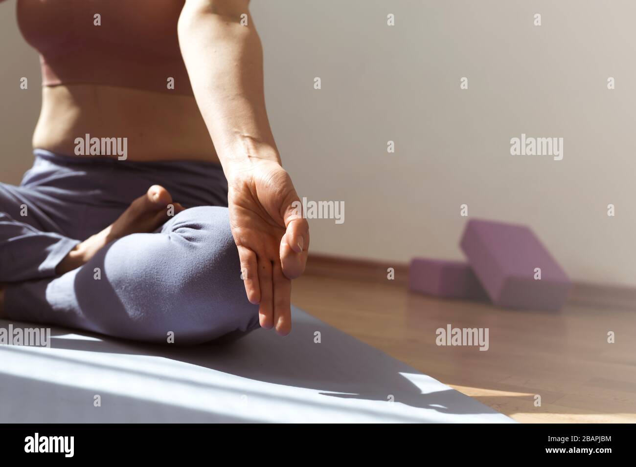 A woman is meditating during yoga class. Stock Photo