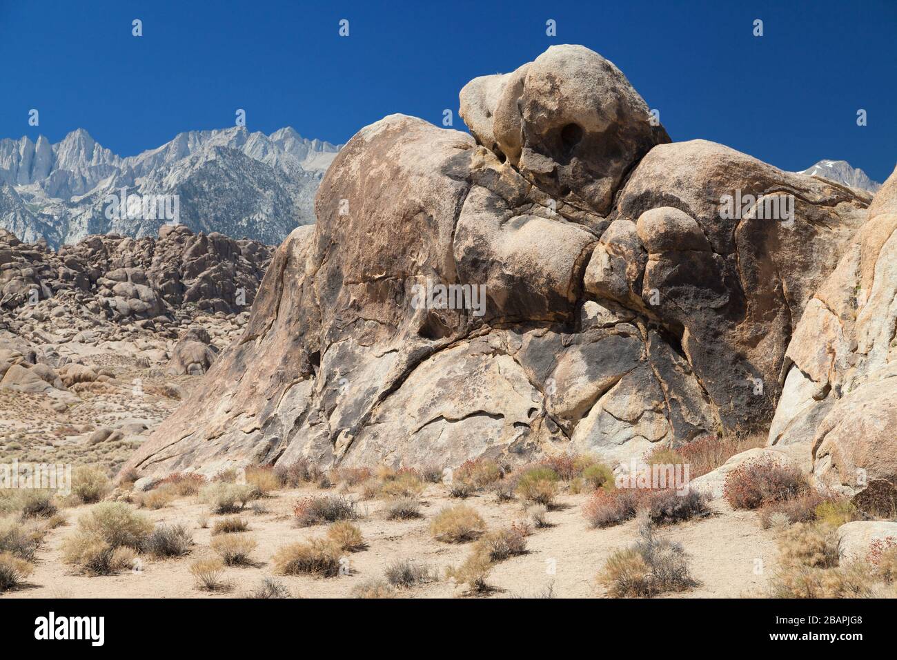 Huge boulder of Alabama Hills with the Mount Whitney in the background, Lone Pine, California, United States. Stock Photo