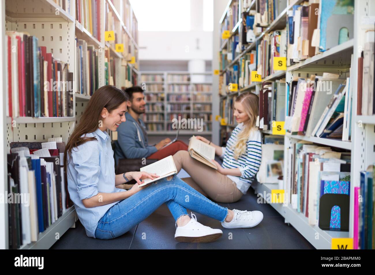 University students working in the library at campus Stock Photo