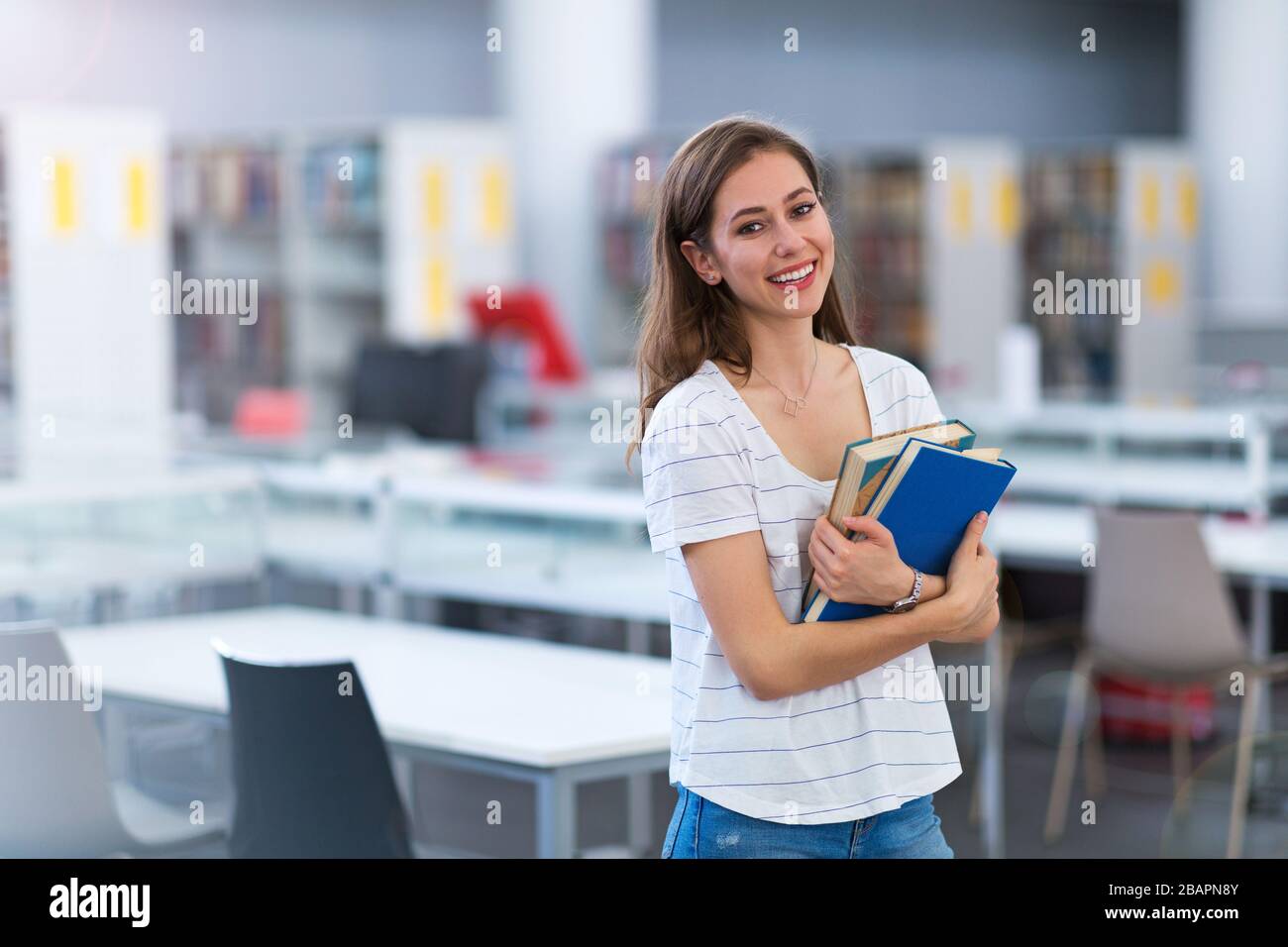 Young female student studying in the library Stock Photo