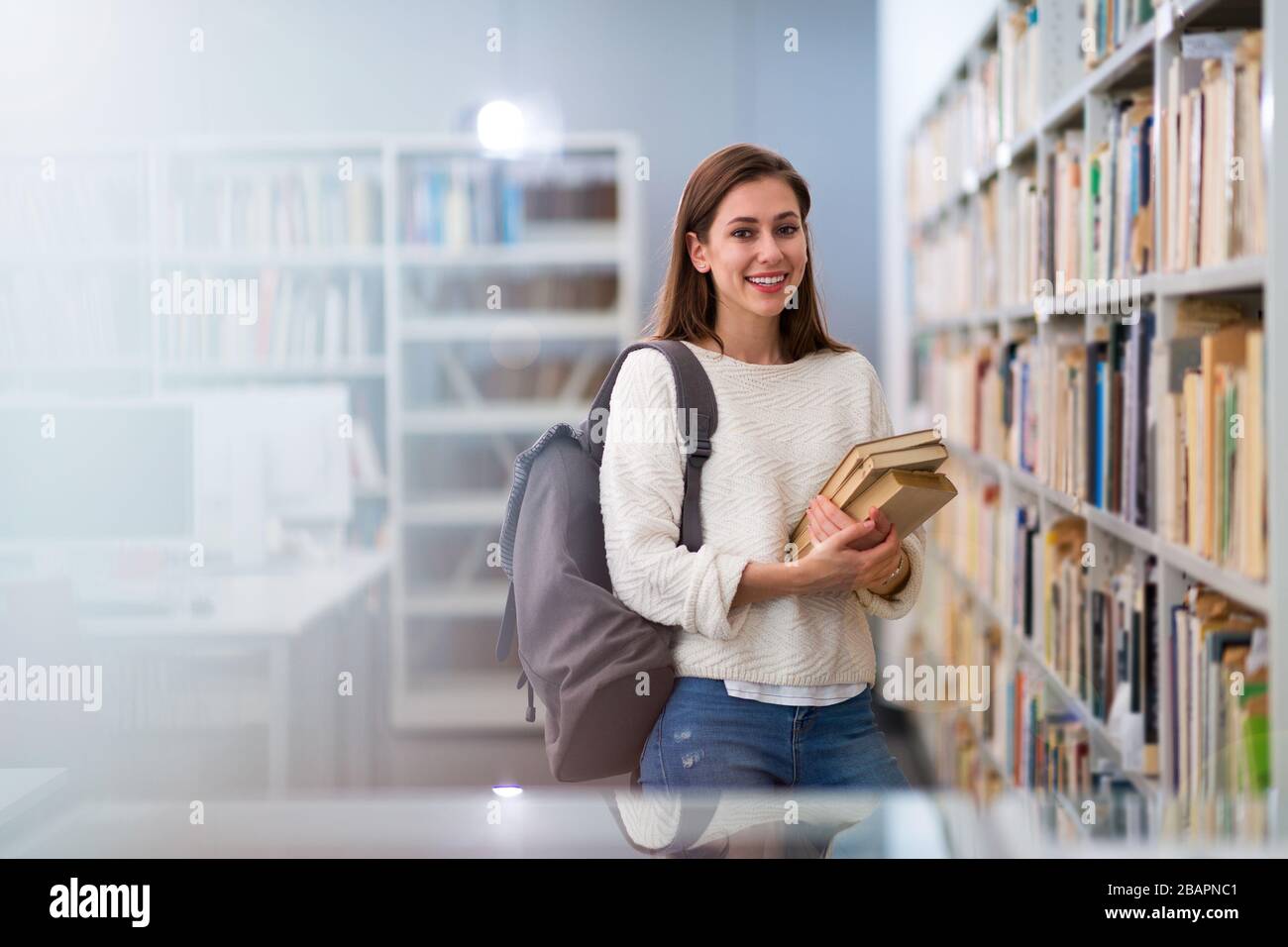 Young female student studying in the library Stock Photo