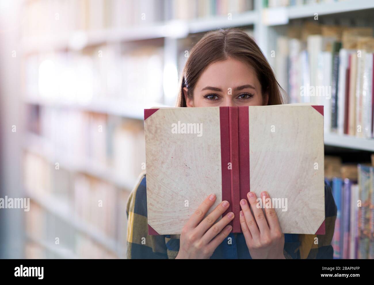 Young female student studying in the library Stock Photo