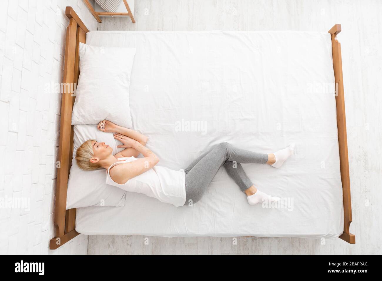 Top view of mature woman sleeping in bed at home Stock Photo