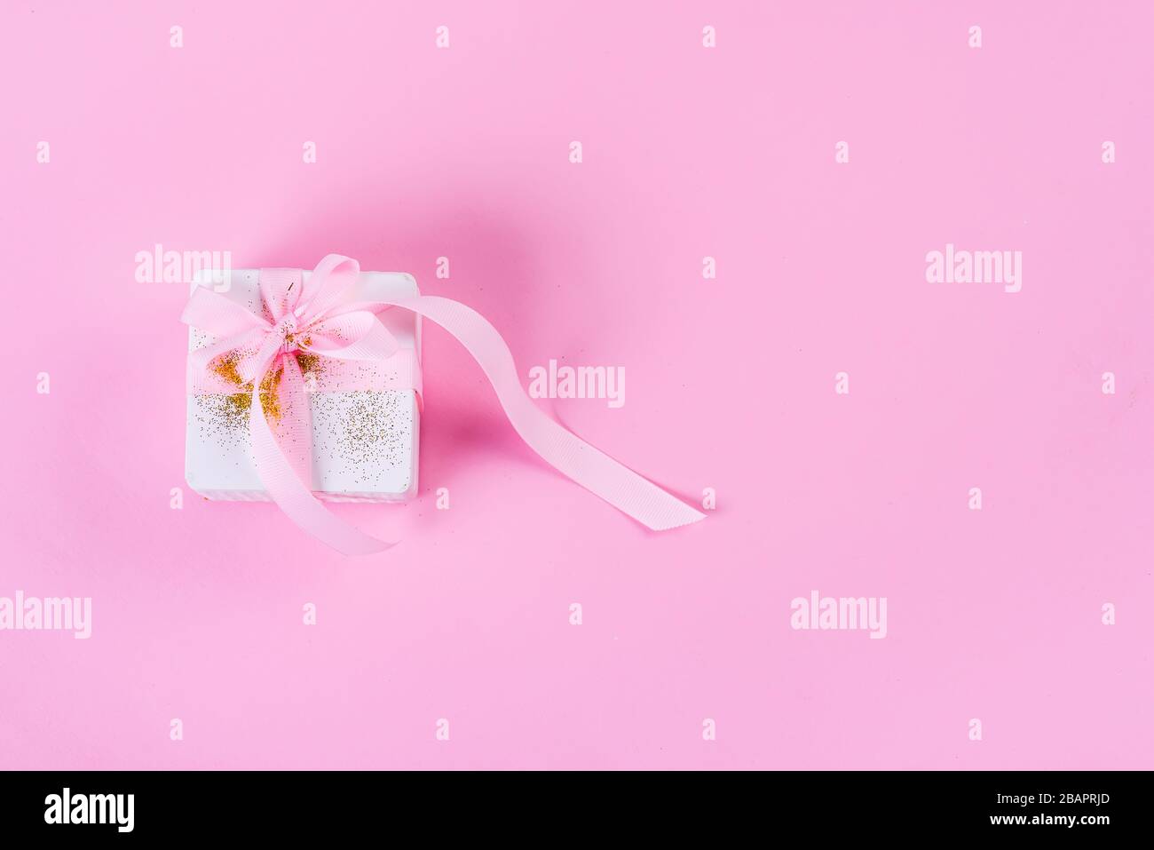 Gift box tied pink ribbon hi-res stock photography and images - Alamy