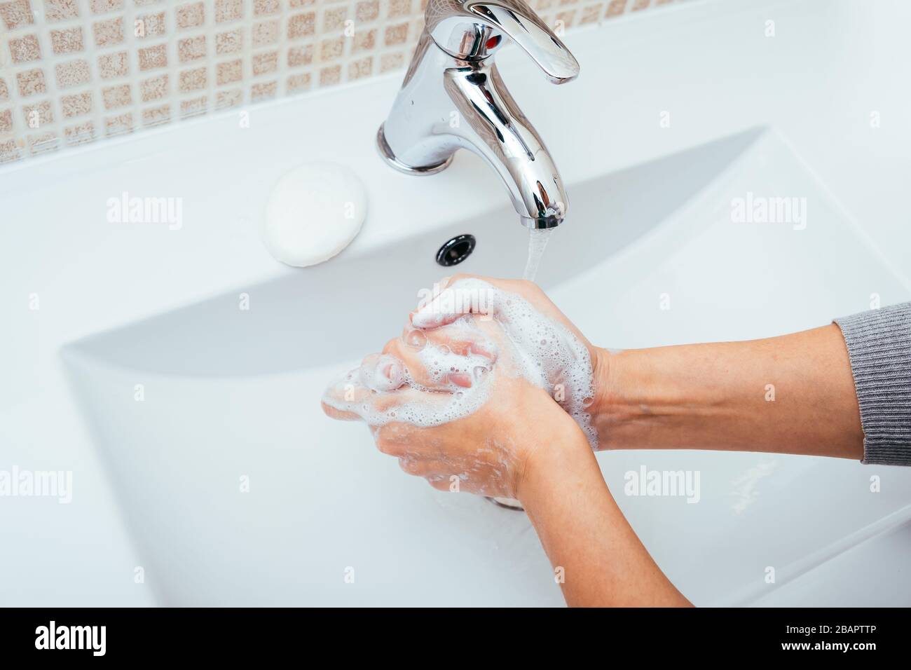 Woman Washing her hands with soap and water at home bathroom. Cleansing ...