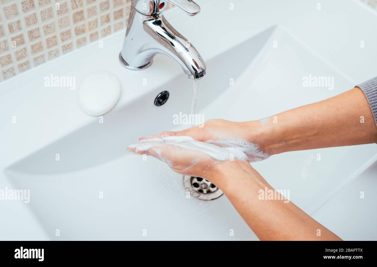 Woman Washing her hands with soap and water at home bathroom. Cleansing ...