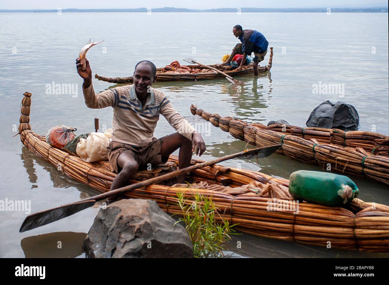 Traditional Tankwas (reed boats) on the banks of Lake Tana. A young fisherman with his canoe on Lake Tana in Bahir Dah in Ethiopia. Lake Tana is the s Stock Photo