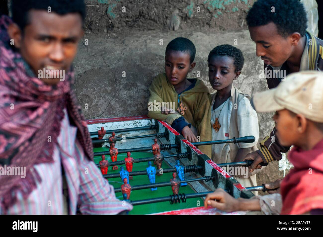 Market place. Debark. Simien Mountains. Northern Ethiopia. Debark Market. Several children play foosball while their parents are selling or buying. Th Stock Photo