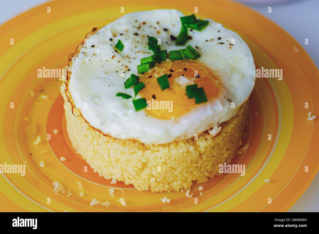 Fried egg with couscous Light background Stock Photo Alamy