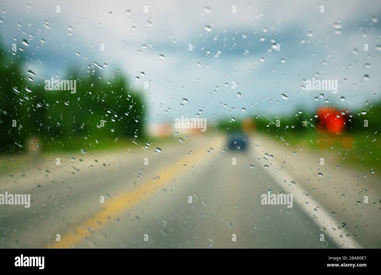 Rain drops on car window during drive Stock Photo Alamy