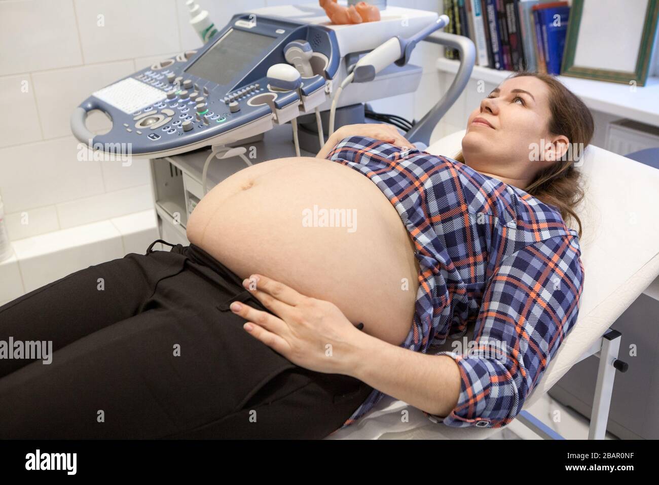 Pregnant wife during medical examination of ultrasound scanning ...
